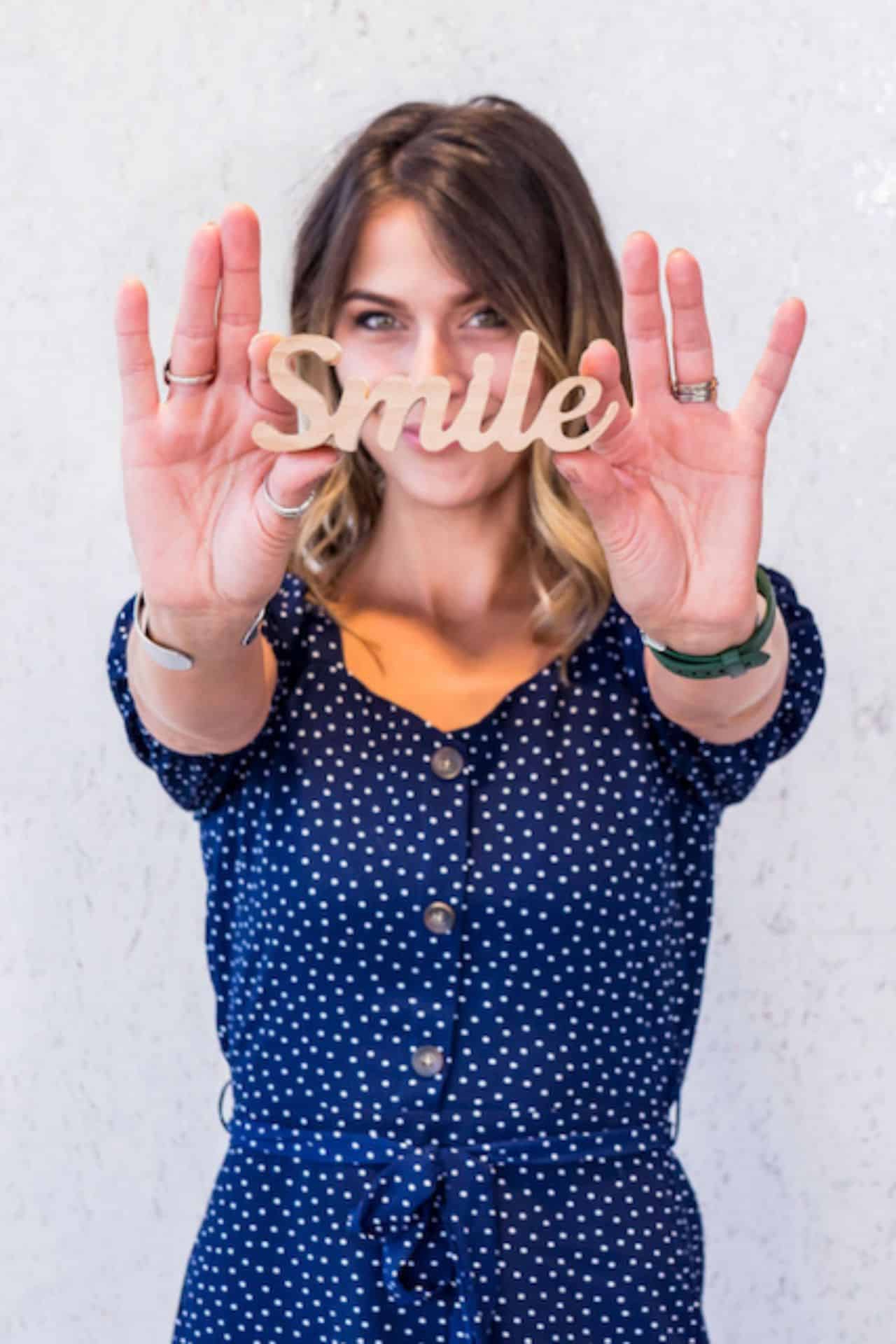 Horton orthodontics | woodbury, mn | invisalign® | braces 11 Horton ortho patient holding smile sign