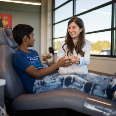 Our story: horton orthodontics 3 Dr. Horton working with a patient, representing horton orthodontics