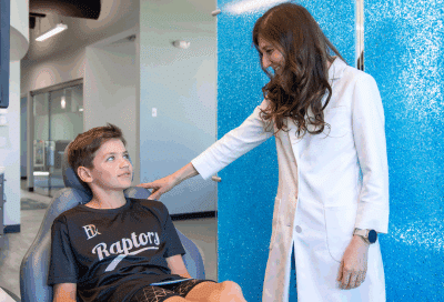 Can you make the change from braces to invisalign during treatment? 6 Dr. Horton talking to a teenage boy patient, representing change from braces to invisalign