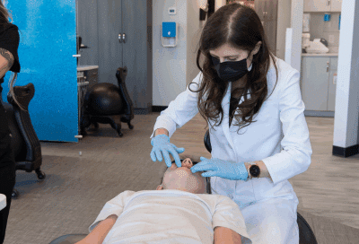 Celebrate national orthodontic health month: orthodontic treatment in woodbury mn 5 Dr. Heather horton working on a patient's teeth, representing orthodontic treatment in woodbury mn
